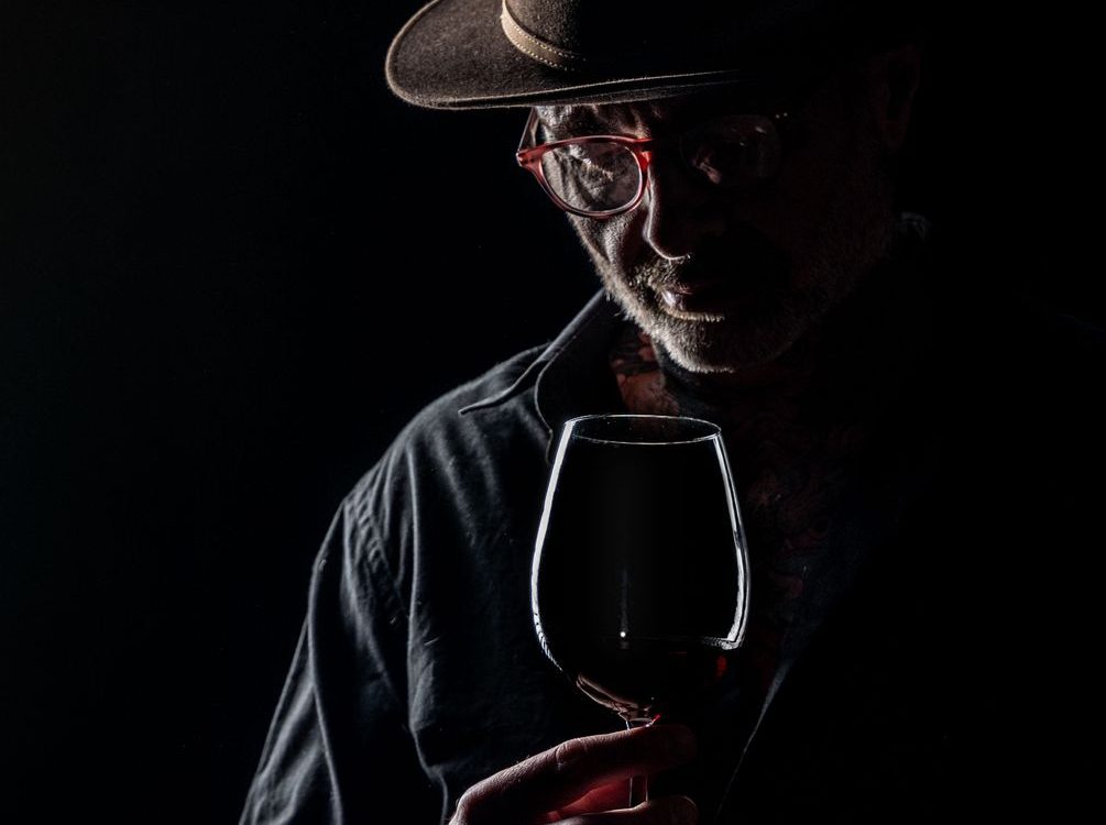 moody portrait of man with wine glass