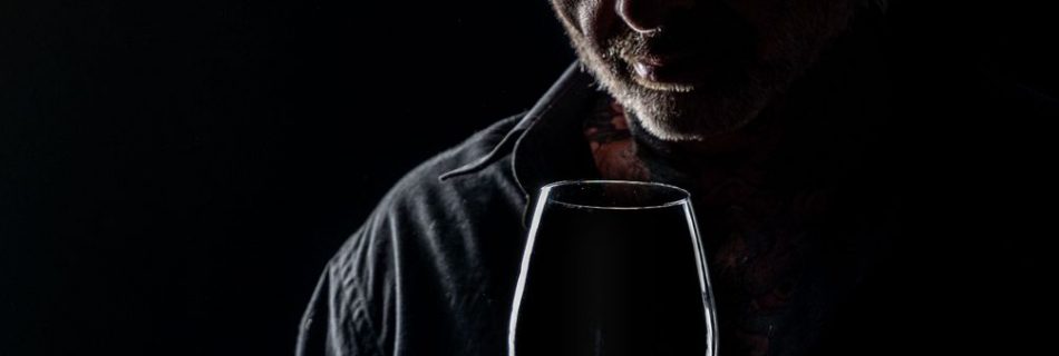 moody portrait of man with wine glass